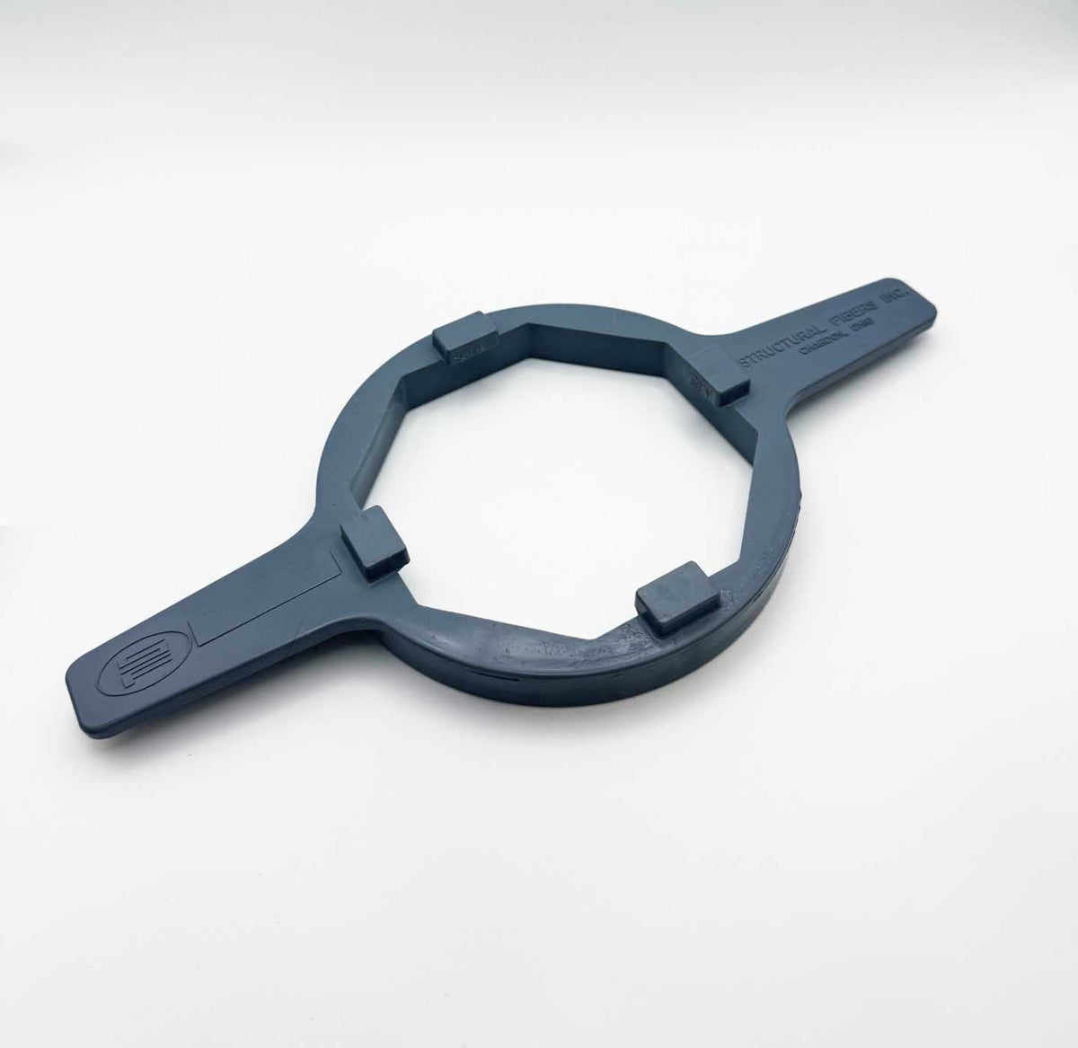 Wrench for Hexagonal 4" Closure, dark blue molded plastic with a circular hexagonal opening and two flat handles.